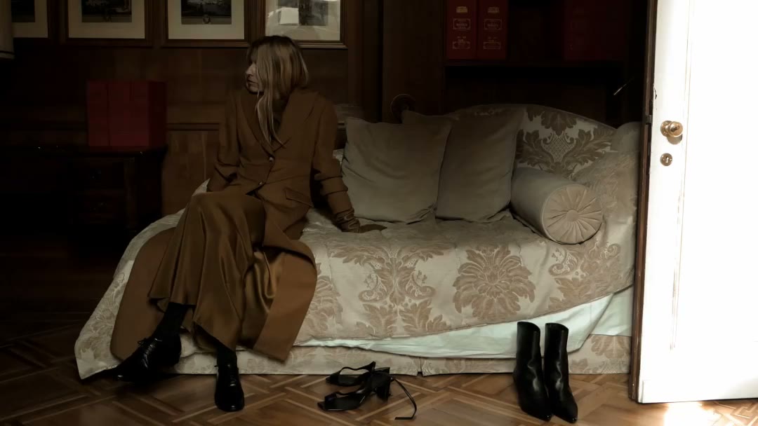 Viviane wears Gaia coat over bronze Beatrice dress—a long-sleeve, floor-length…