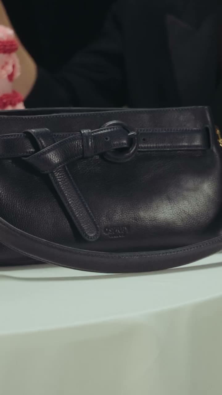 Introducing the East West Belt Shoulder Bag - a bag that moves effortlessly…