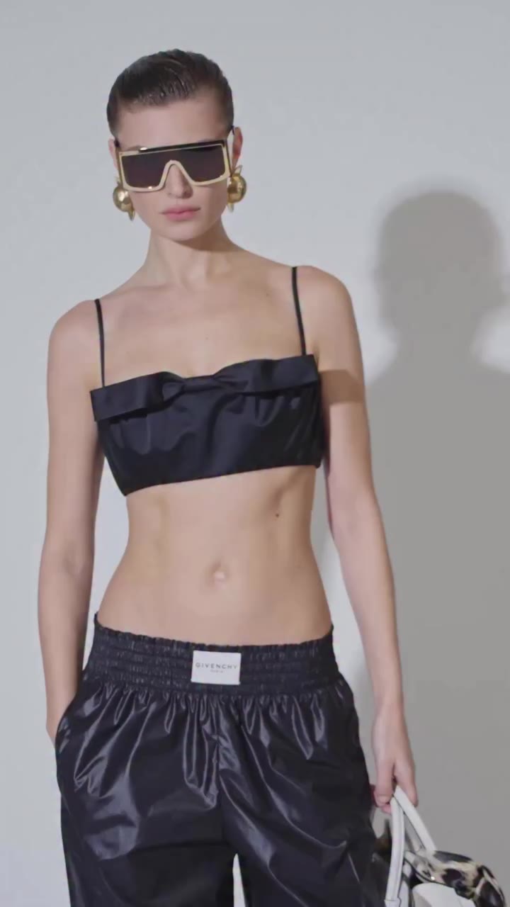 Bibi wears a bra top with bow detailing, joggers in technical poplin and the…