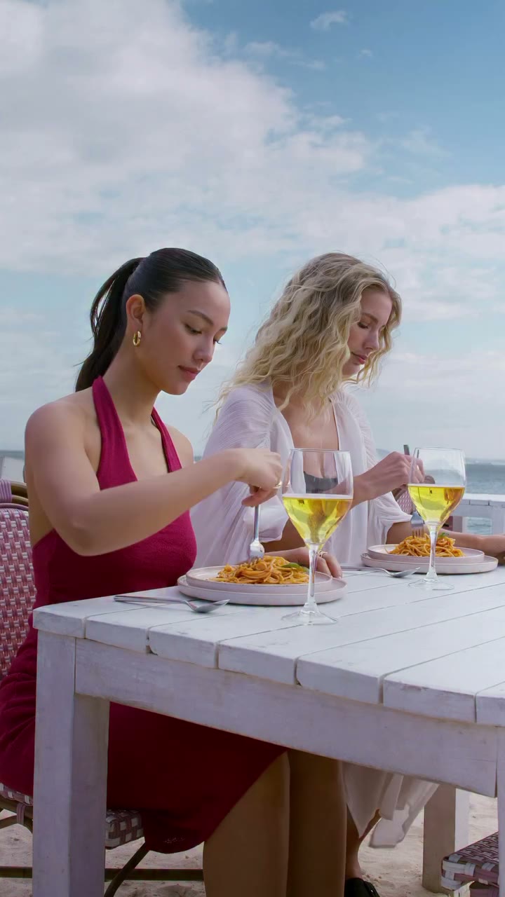 A table in the sand, the scent of fresh pasta in the air, glasses clinking…