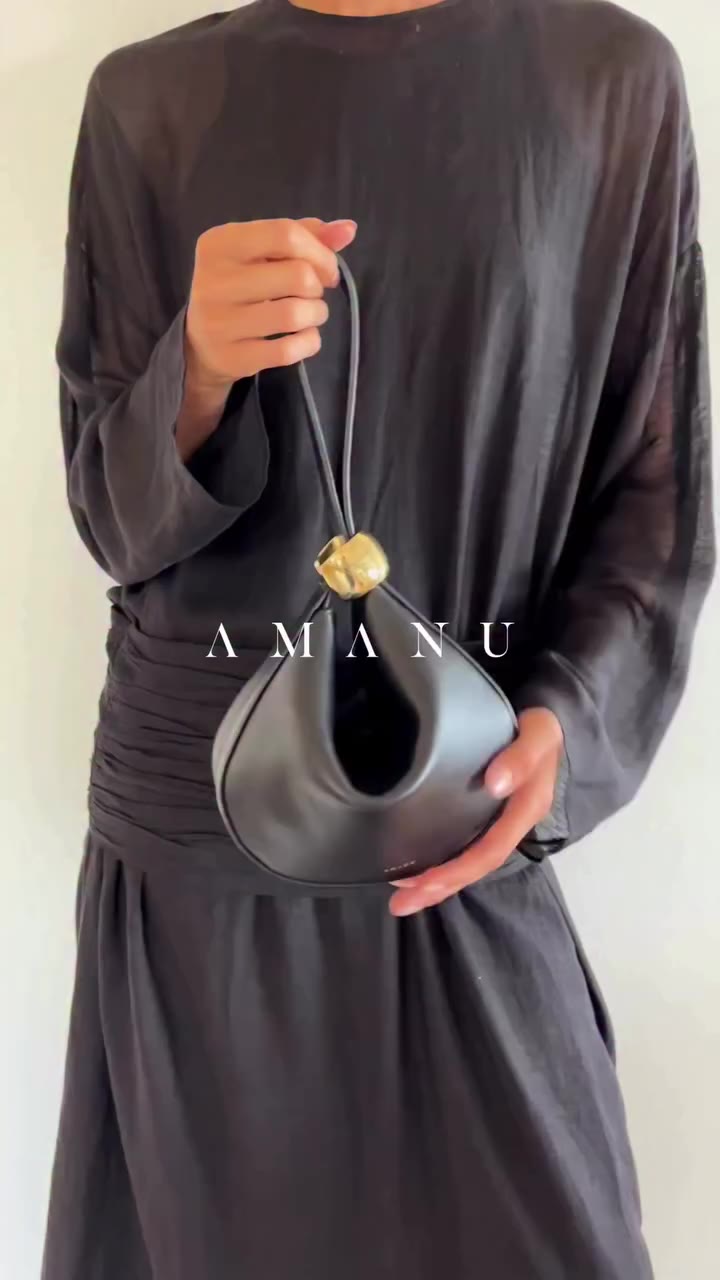 The Zambia in black, opened and closed. The rings slide along the strap, a…