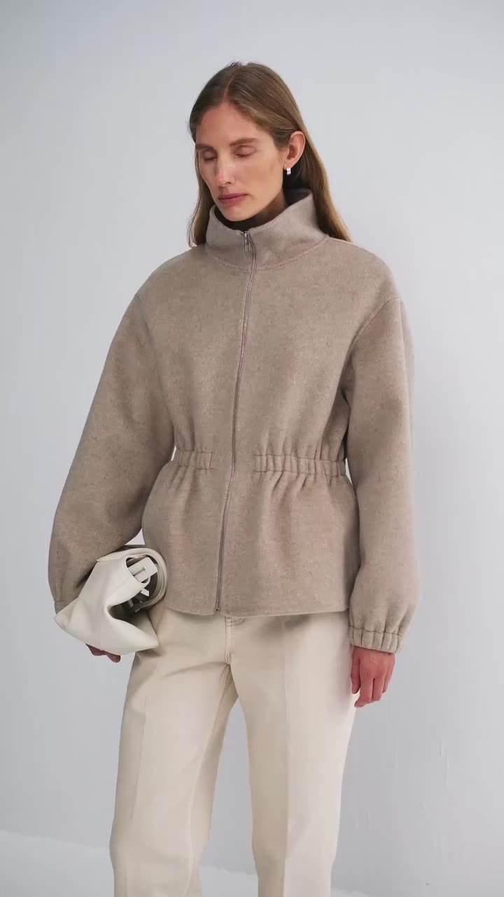 Gently cinched. Softly curved. Rendered in understated oatmeal. The Valleria…