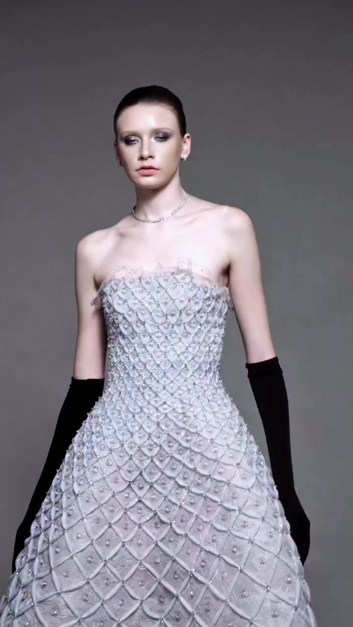 Hand-dyed icy blue guipure lace is carefully shaped and refined through…