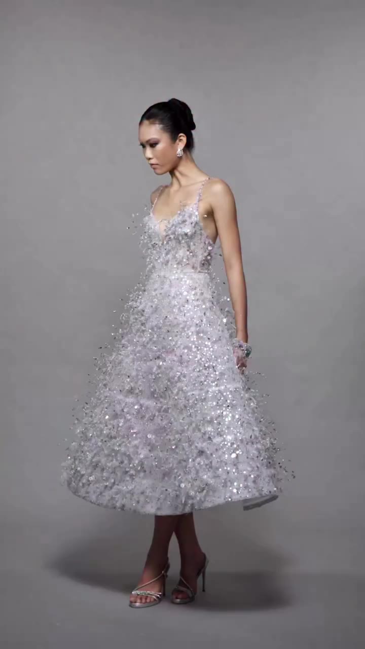 A luminous silvery blue guipure lace dress, detailed with thousands of…