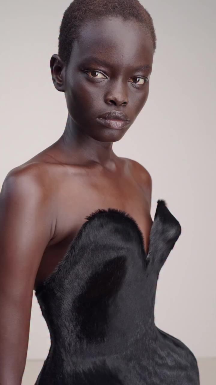 A sculptural silhouette crafted from glossy black horsehair. The pronounced…