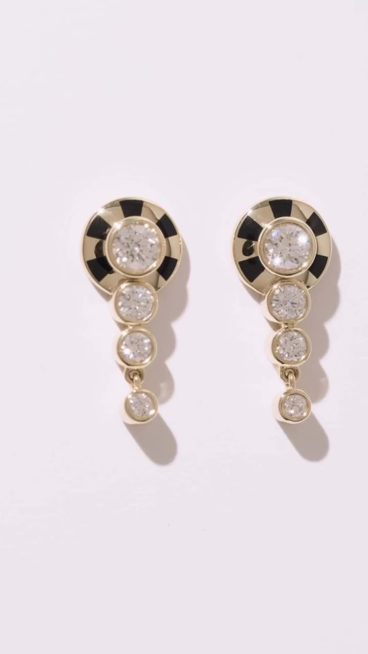 One ripple holds a diamond ringed in Jet Black enamel, its fringe trailing…