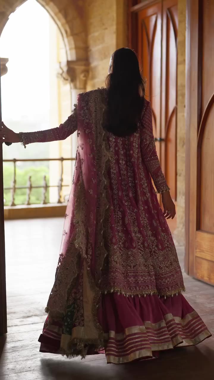 Riwayat A stunning rose-pink ensemble adorned with intricate silver-gold…
