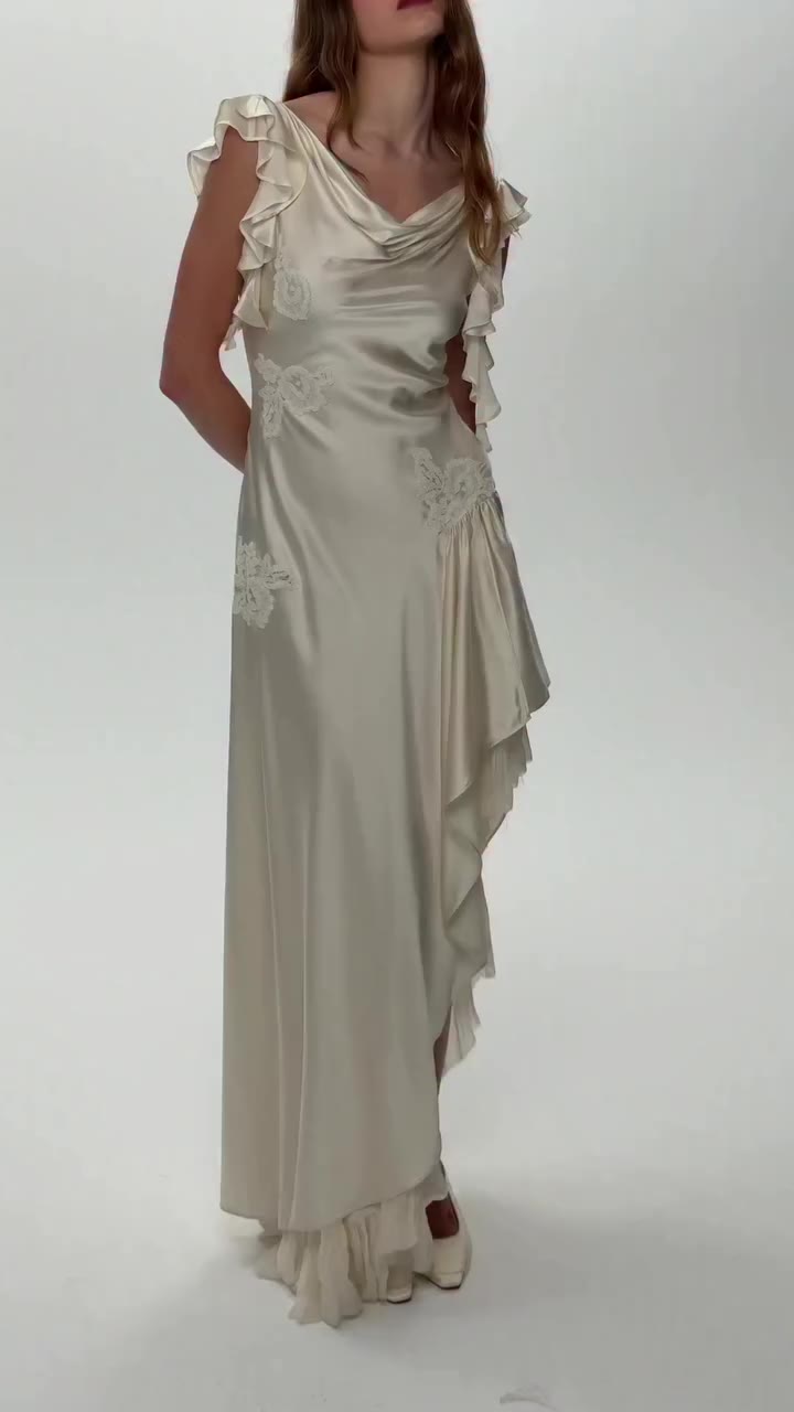 a lustrous silk bridal gown with floral lace accents that bring an heirloom…