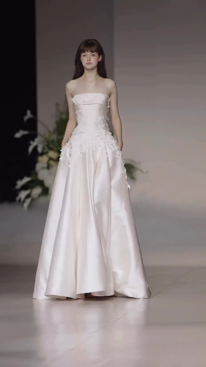 Sculptural 3D florals bloom across pure satin, while a distinctive winged open…