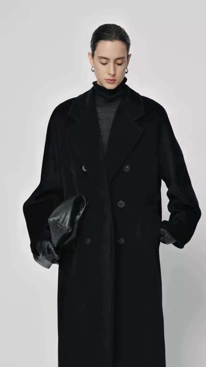 Structured double-breasted wool coat where precise tailoring meets restrained…