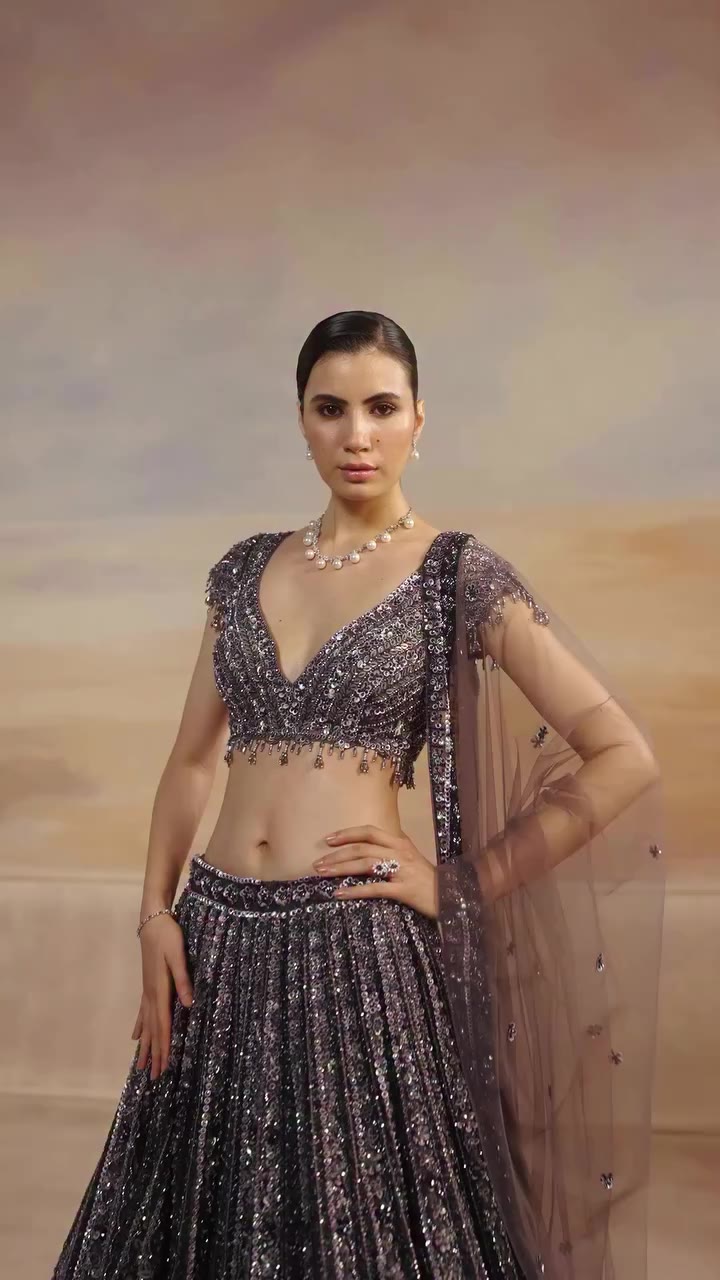 Subtle grey-blue tones with a serene botanical influence. The Sylven Lehenga…