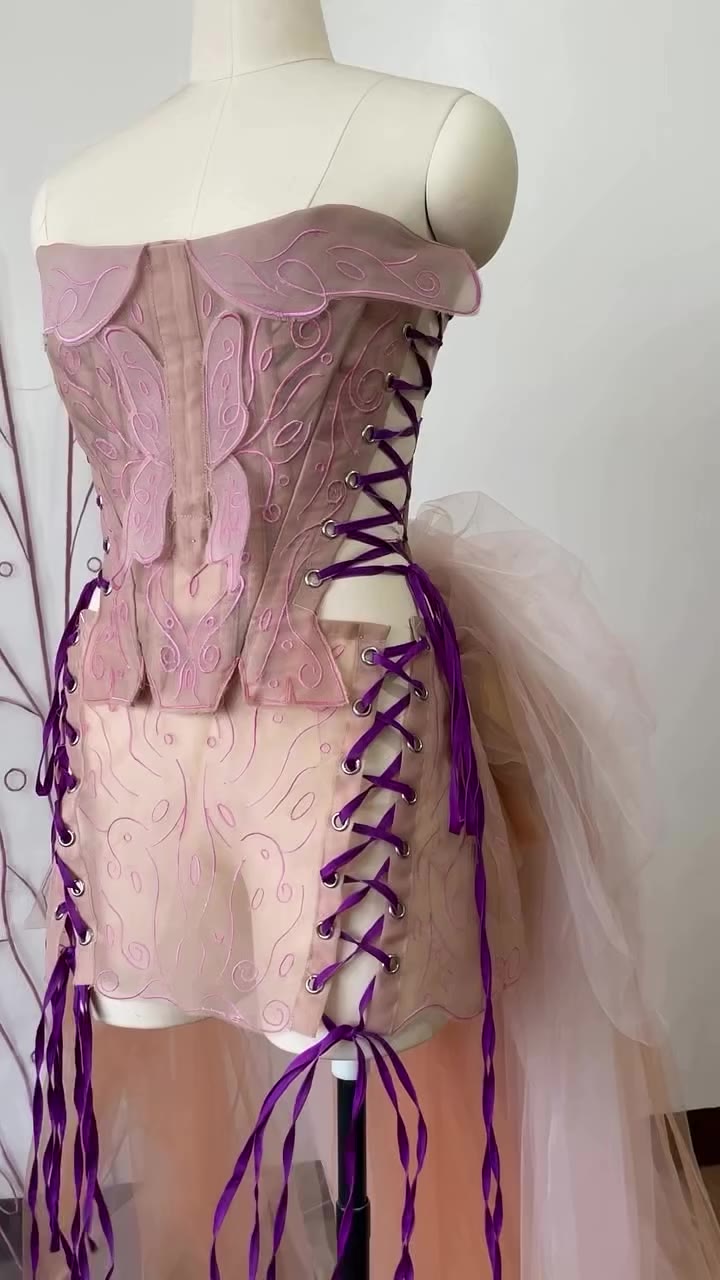 Reimagined embroidered stays, mini skirt, and bustle by Jan Paul Martinez…