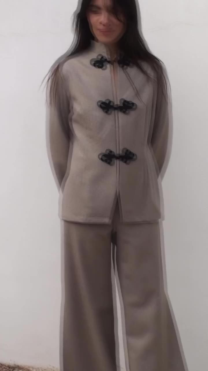 The Wilma Loden Wool Overshirt in beige. It’s crafted from fulled merino wool…