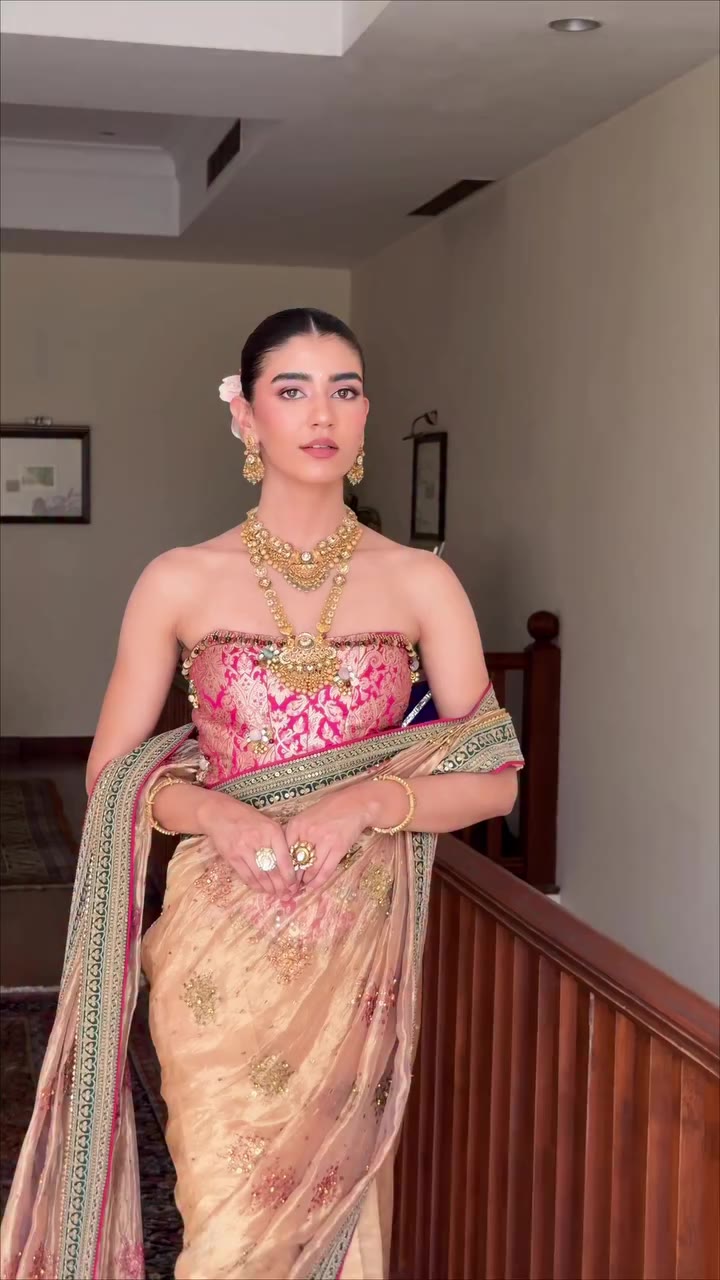 Draped in a champagne-hued saree, she embodies the refined craftsmanship and…