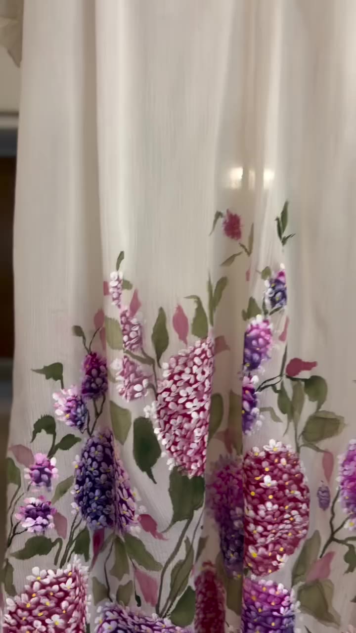 A custom silk chiffon dress, hand-painted with delicate hydrangeas, made…