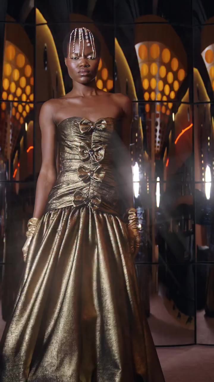 Bronze takes on a richer evening register, with a corseted waist and rounded…