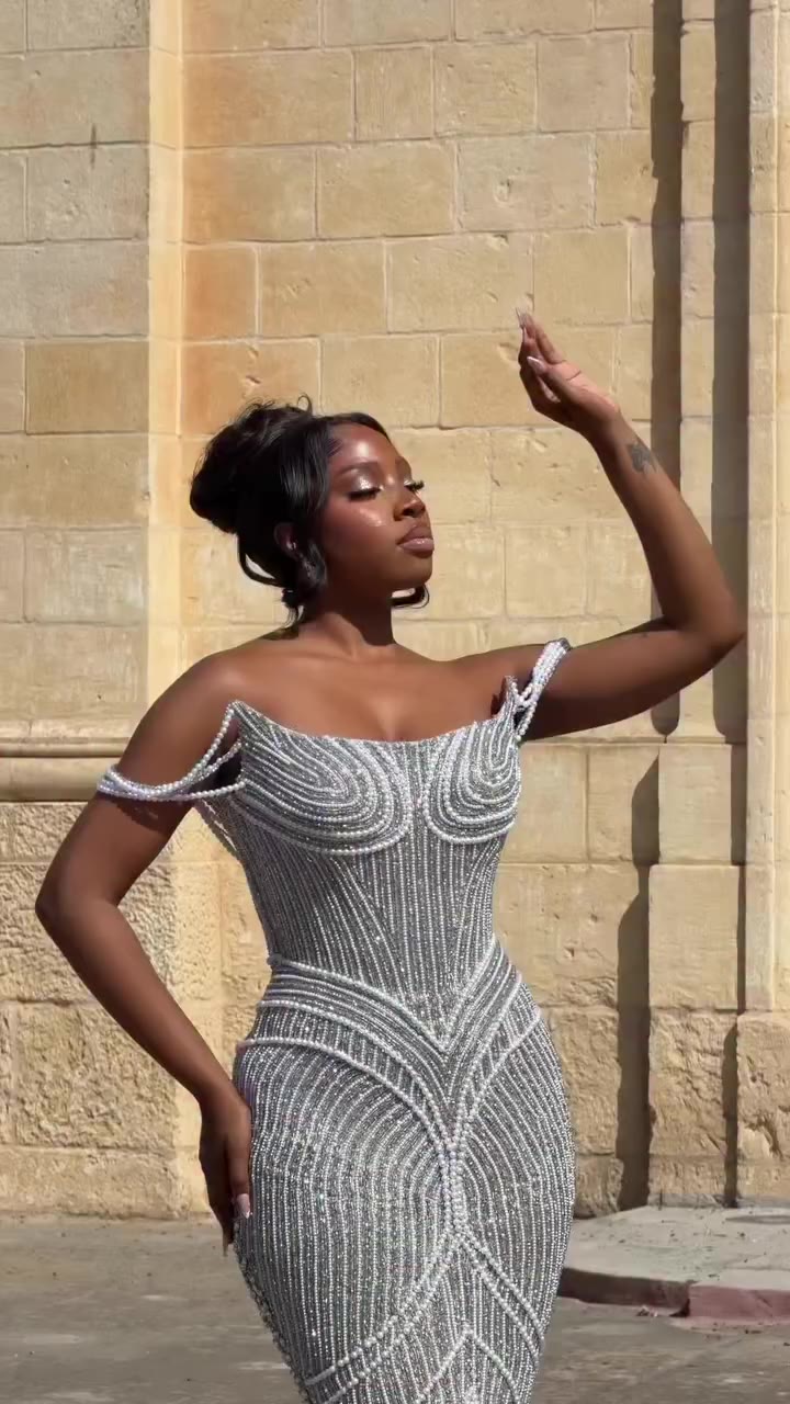 A dress fully adorned with pearls, silver crystals and brilliant stonework…