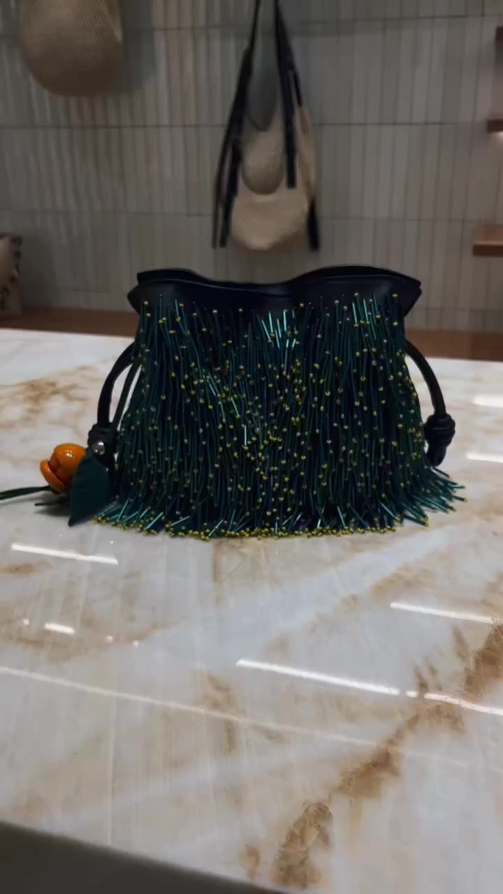 Next in line. The LOEWE bag - the Mini Mimosa Flamenco clutch in beaded nappa…