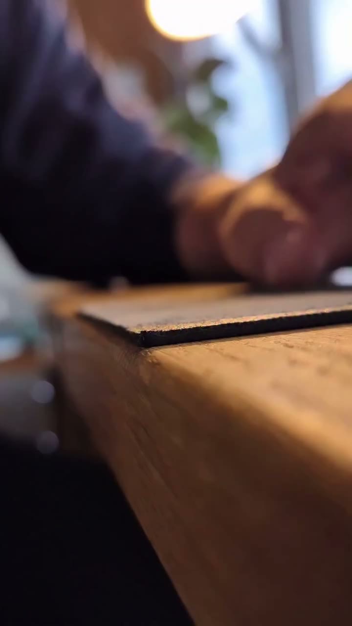 Gluing a black Journeyman Wallet together using a needle tip bottle filled…