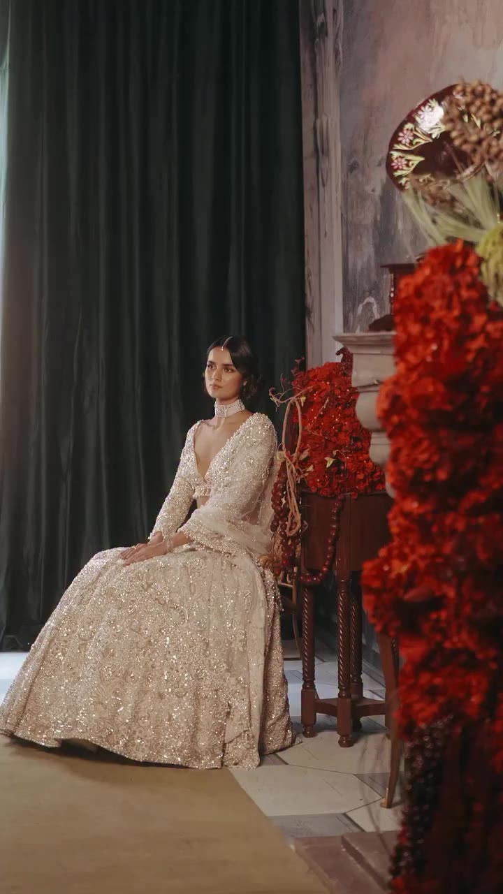 A flourish of florals. Layers of thread work, pearls, and sequins bring the…