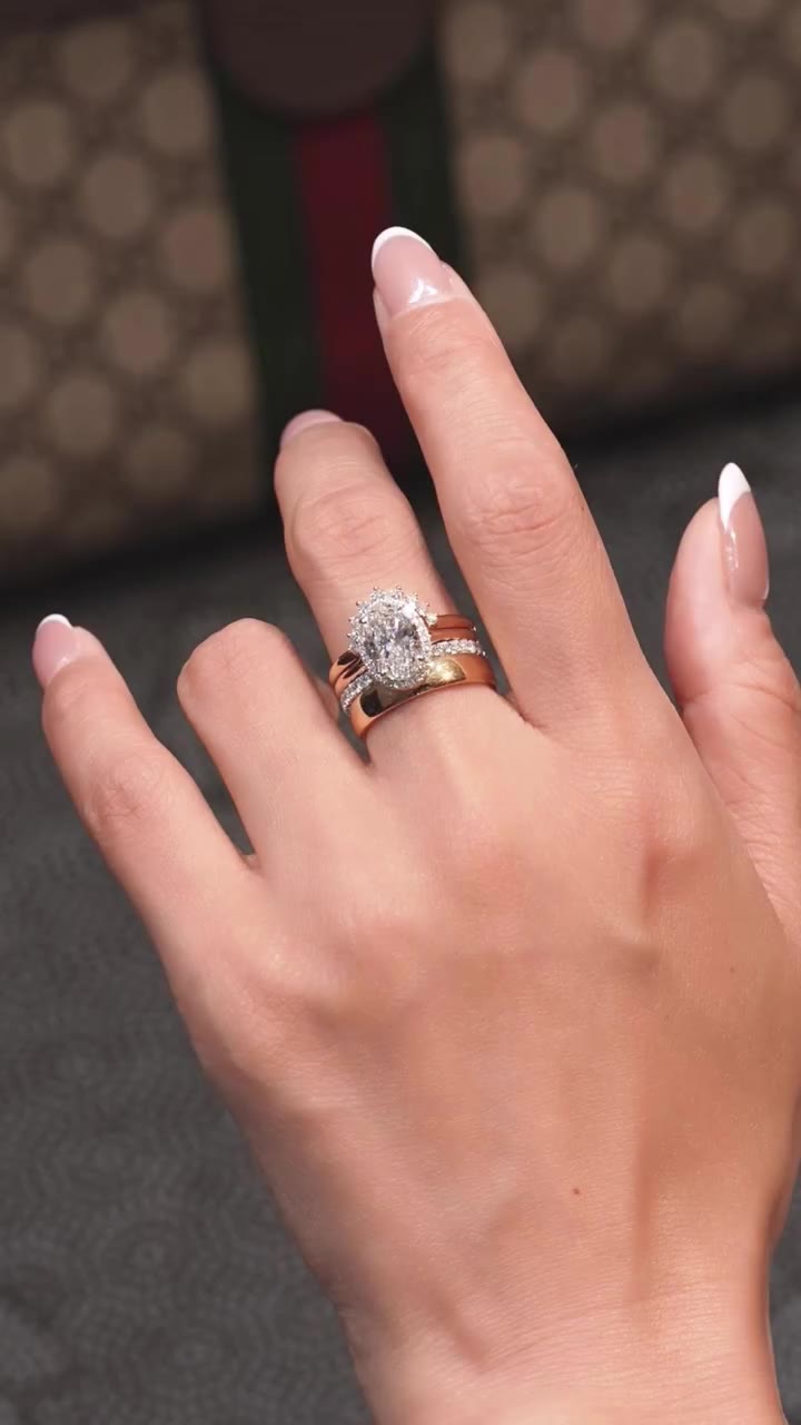 Layer by layer. ✨ Oval halo, pavé band, crown band and a wide gold band — the…