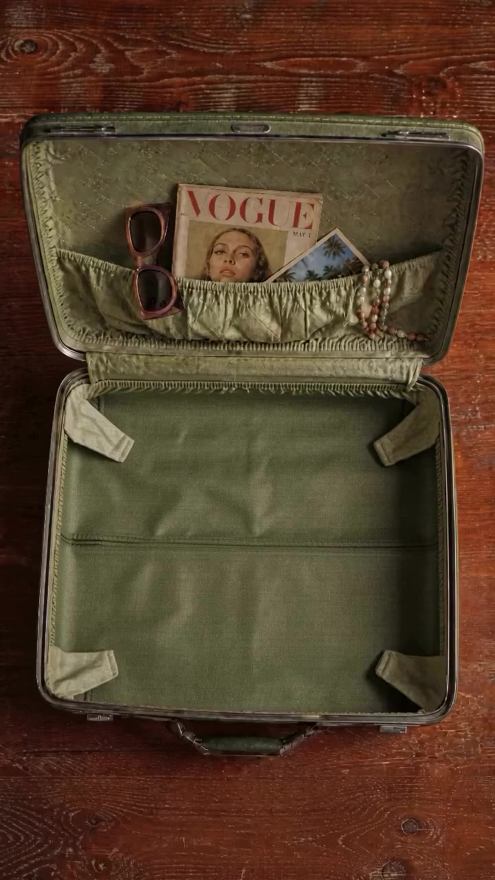 The suitcase found in 1977. Sunglasses, paperback, swim, jewellery, one…