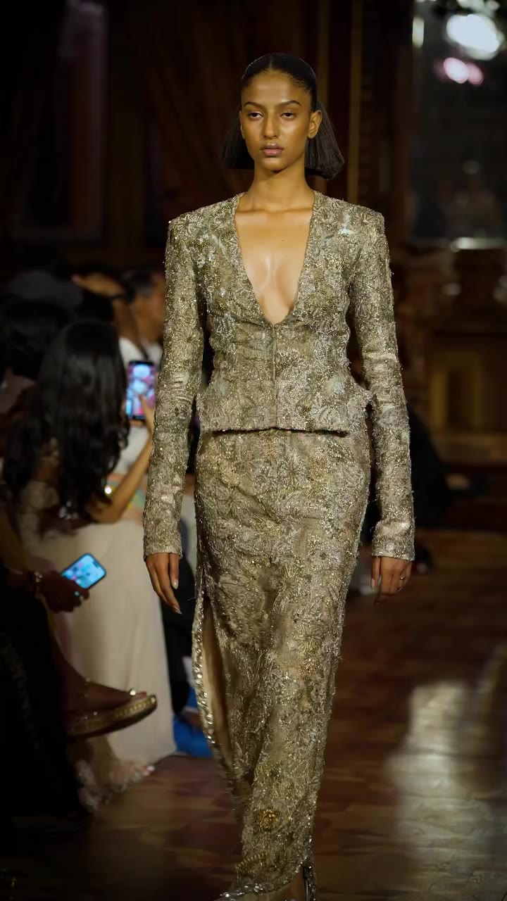 A sharply fitted jacket enriched with intricate gold zardozi embroidery…