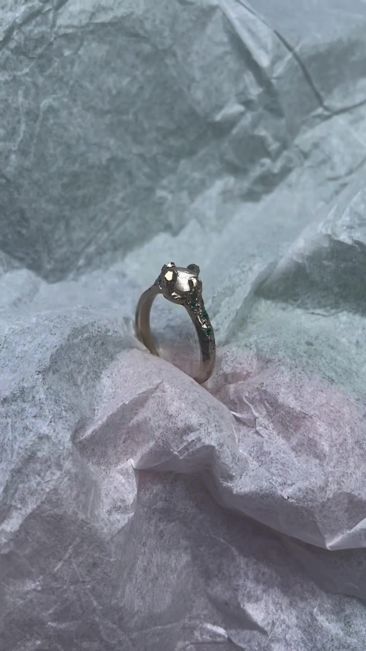 2 years ago, 9k yellow gold with 1ct raw diamond and emeralds