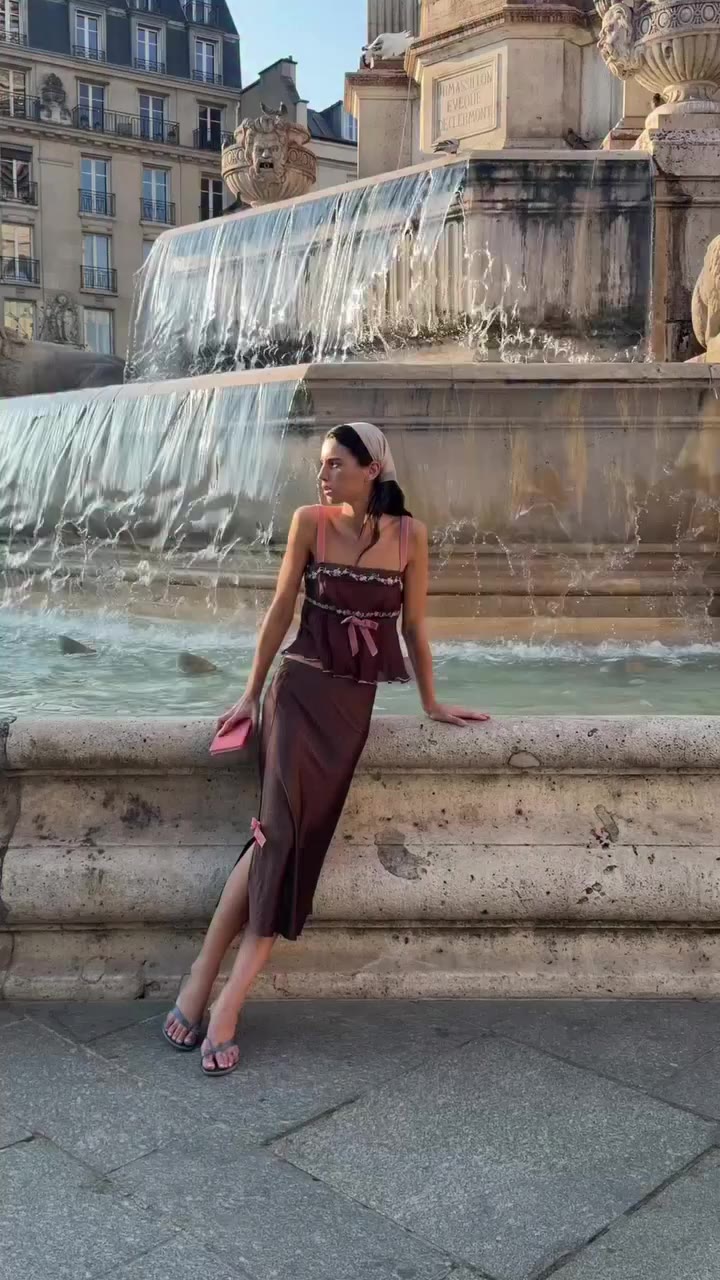 embroidered lace, pink velvet details, and a ruffled lettuce-edge hem make the…