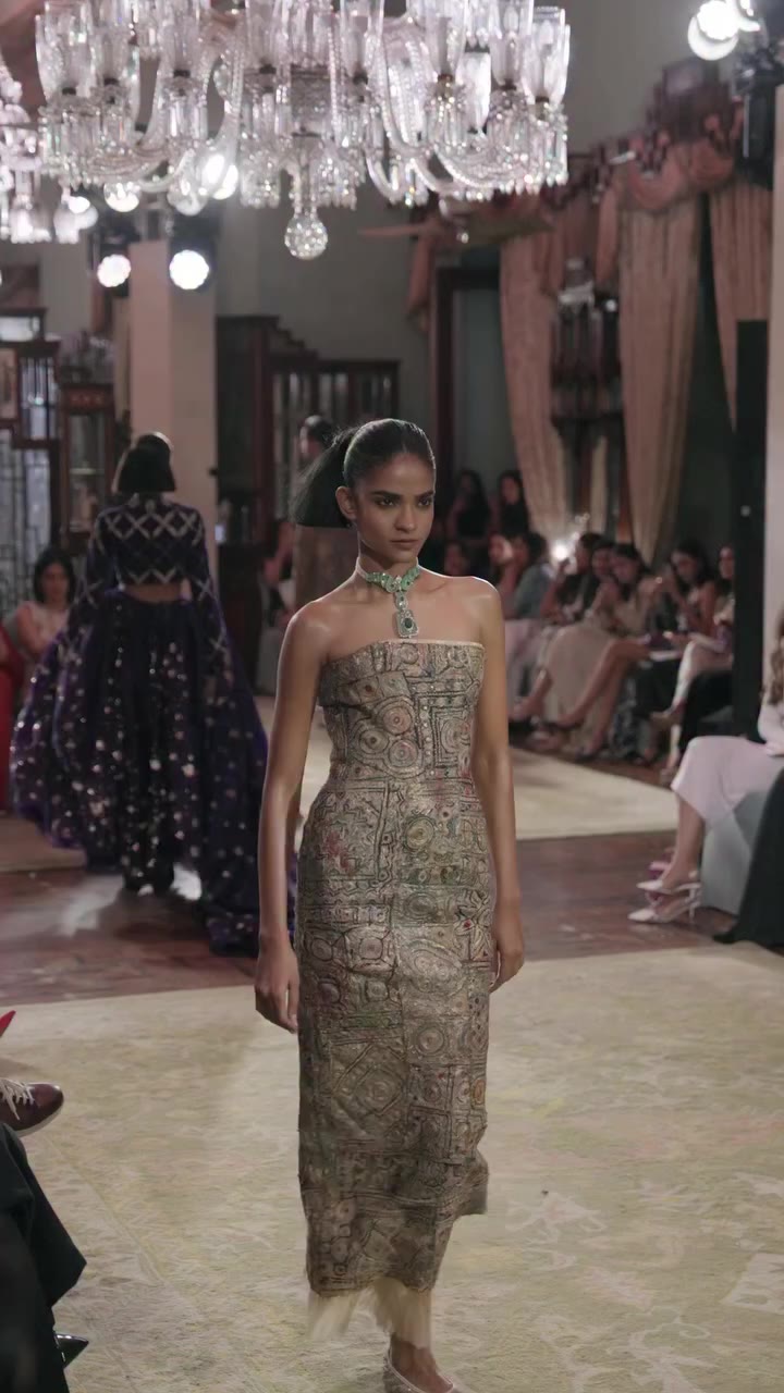 A sculpted tube dress constructed through intricate patchwork, its fitted…