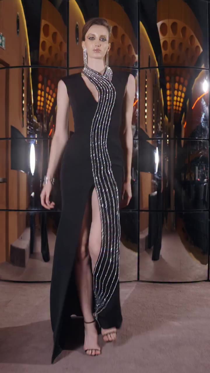 A cascade of silver embroidery lends this black silhouette the allure of fine…