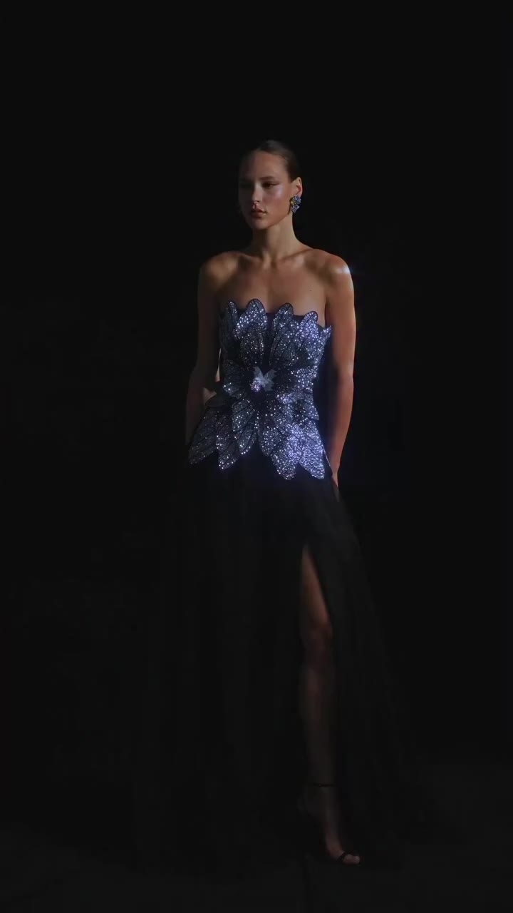 Crystal-embroidered petals gather around a butterfly at the bodice, finished…