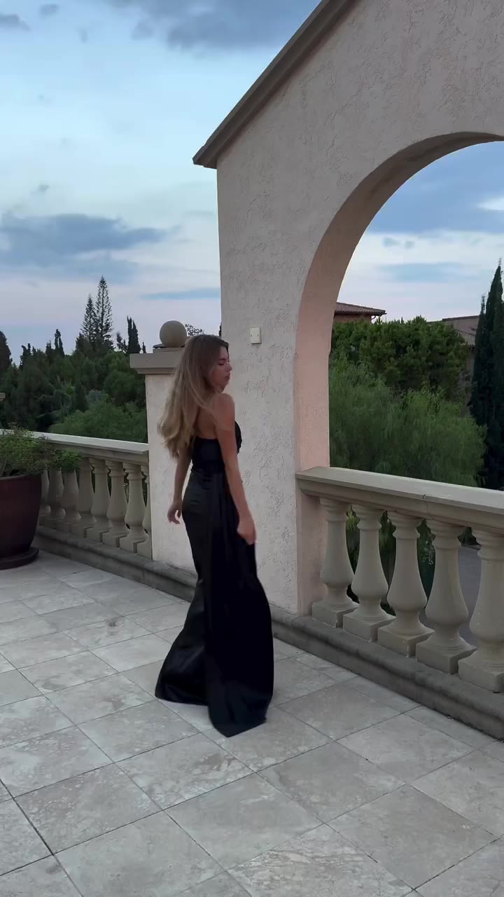 One-shoulder black satin gown 🖤🌙 High slit and flowing side drape create…