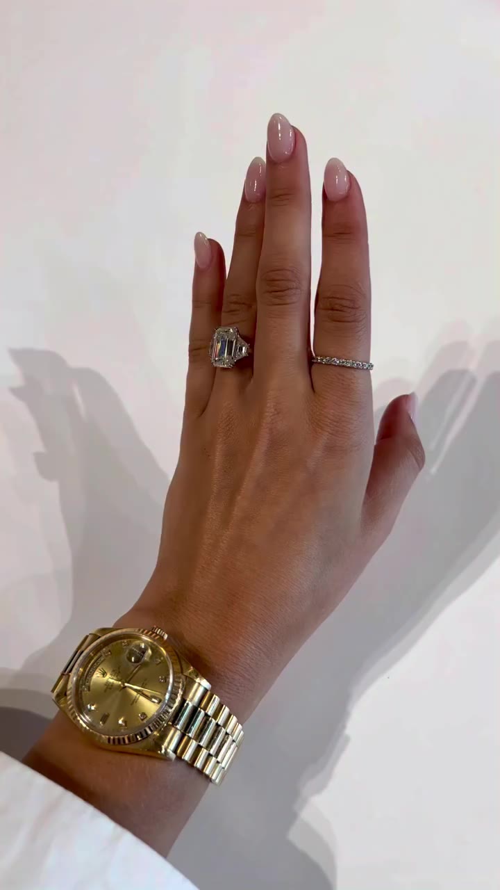 A huge 7.1 carat emerald with healthy sized trapezoid side stones and a donut…
