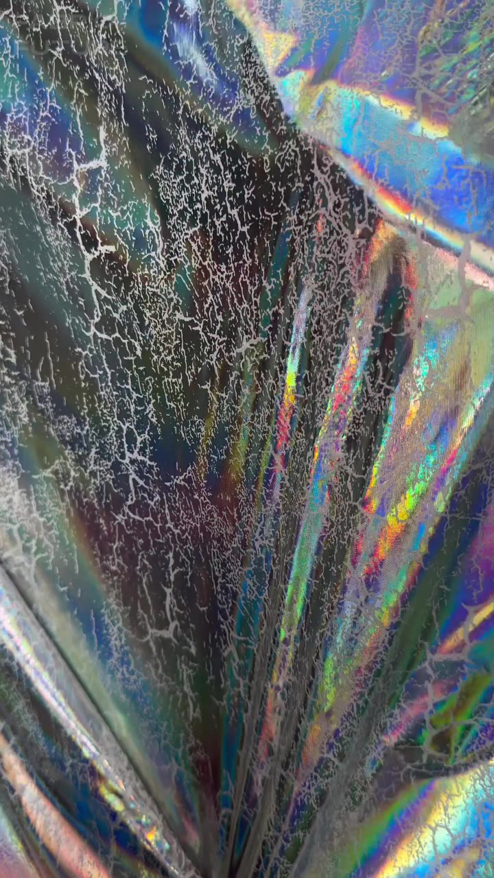 GRUNGE HOLOGRAM ↓ — A high-quality jacket and raincoat fabric featuring a…
