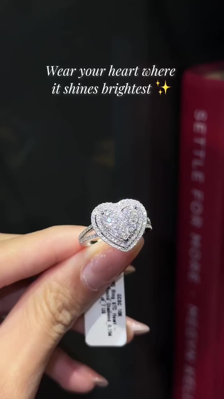 A radiant round diamond, framed in a delicate heart halo, set in 18K white…