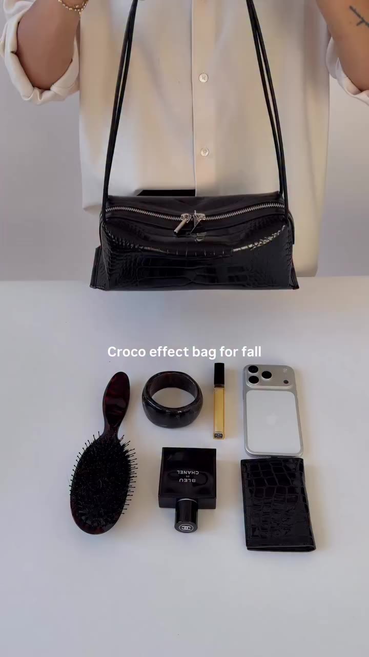 A closer look at the Black Croc Café Midi Bag. Sleek lines, polished silver…