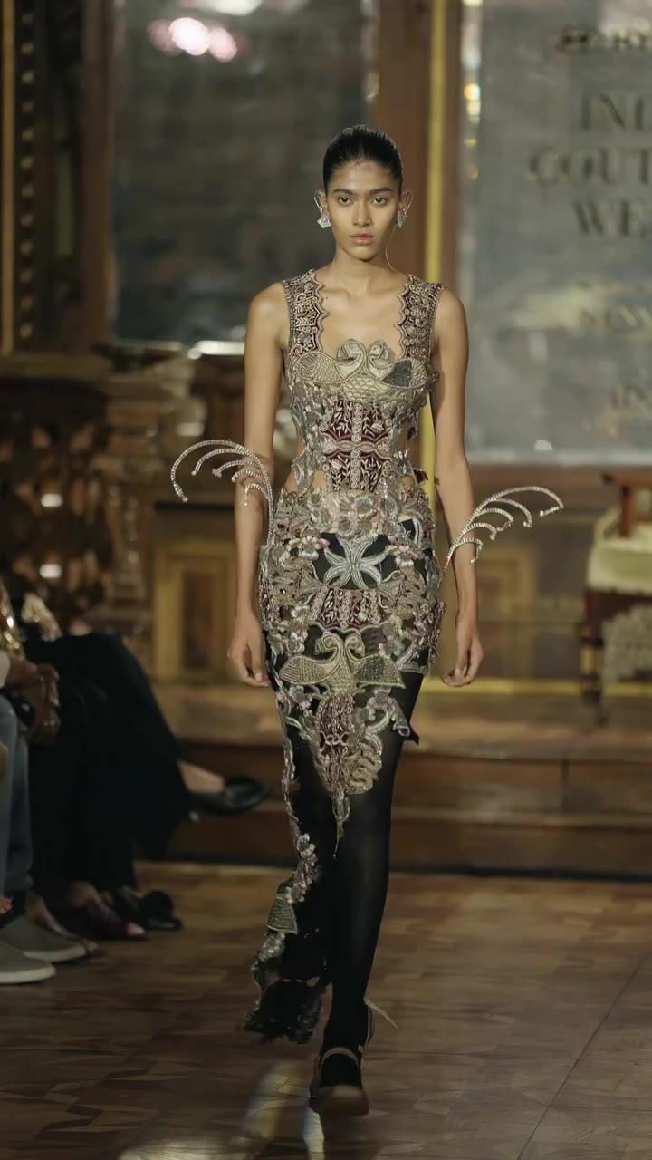 A deep burgundy cut-out long dress enriched with vintage bird motifs and…