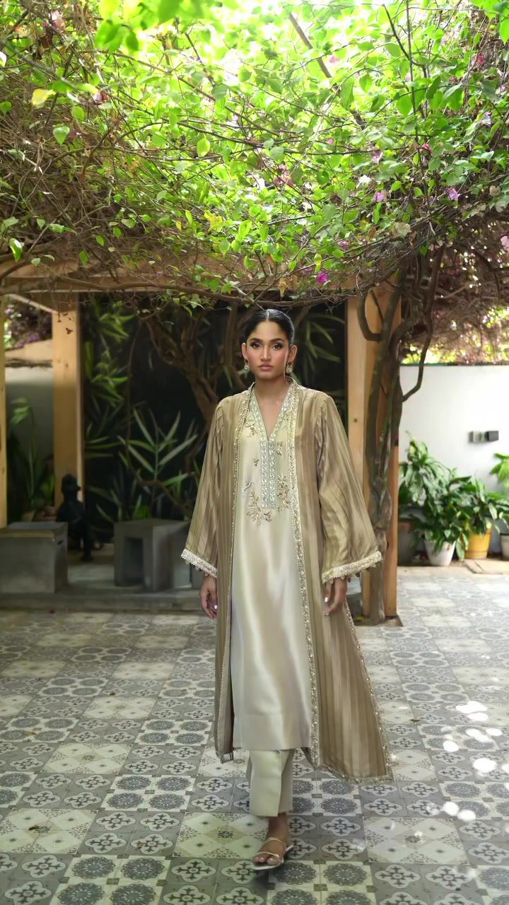 Layers of soft gold and beige — a pleated, textured outer layer framing an…