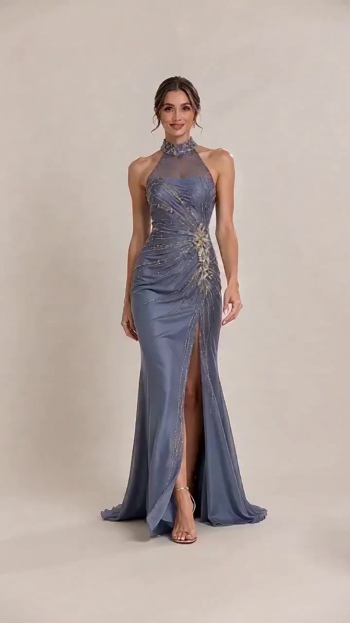 Starry embellishments on dusty blue tulle. This halter evening gown features…