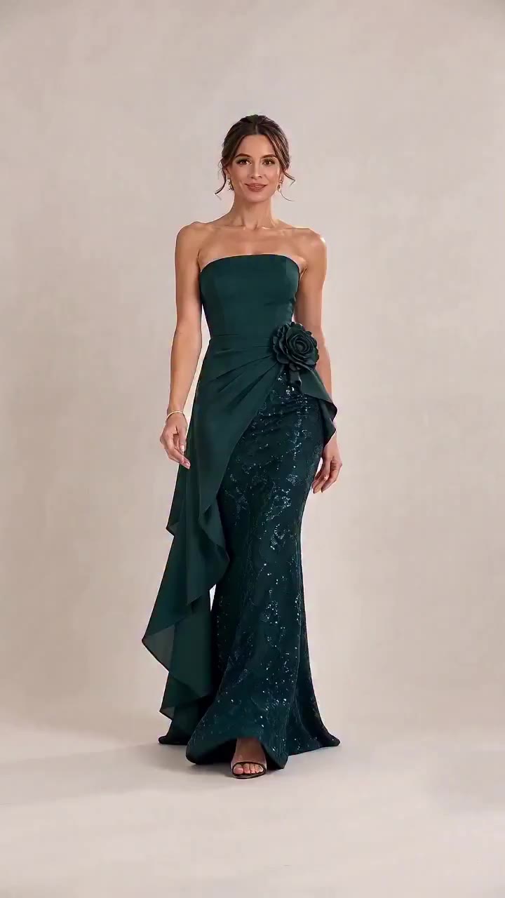 Deep emerald elegance reimagined. Strapless fitted gown with draped fabric and…